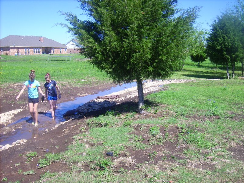 Taylor and Holly walking in the creek