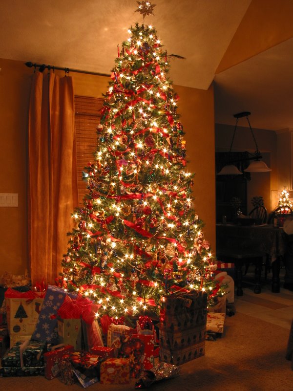 A replenished pile of gifts under the Armstrong Christmas tree