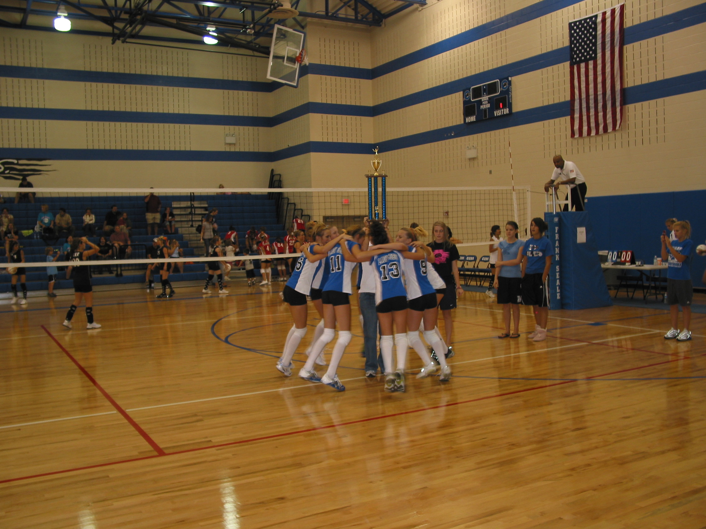 The team dances around the trophy