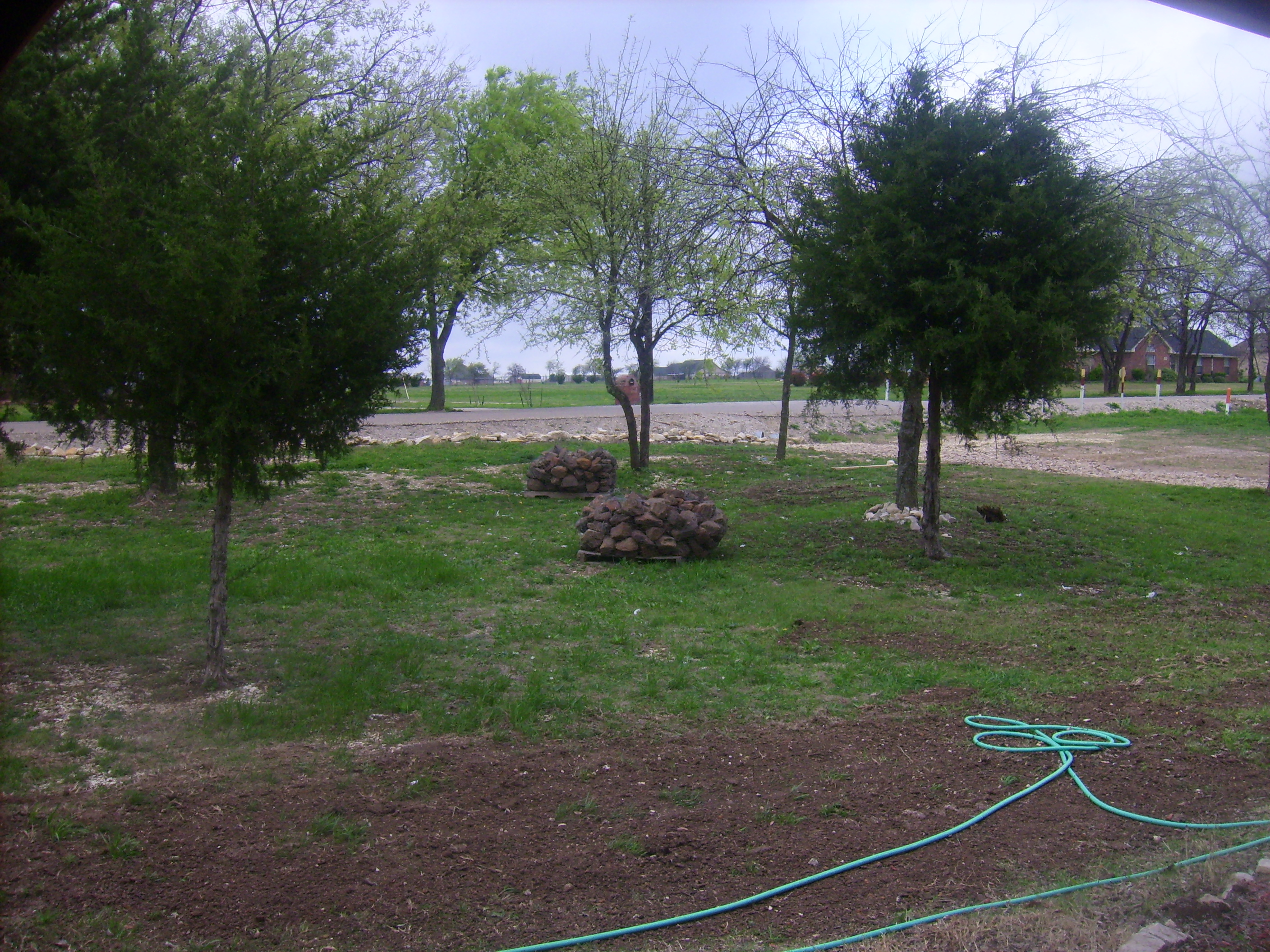 Two pallets of mossy sandstone for creating tree border rings