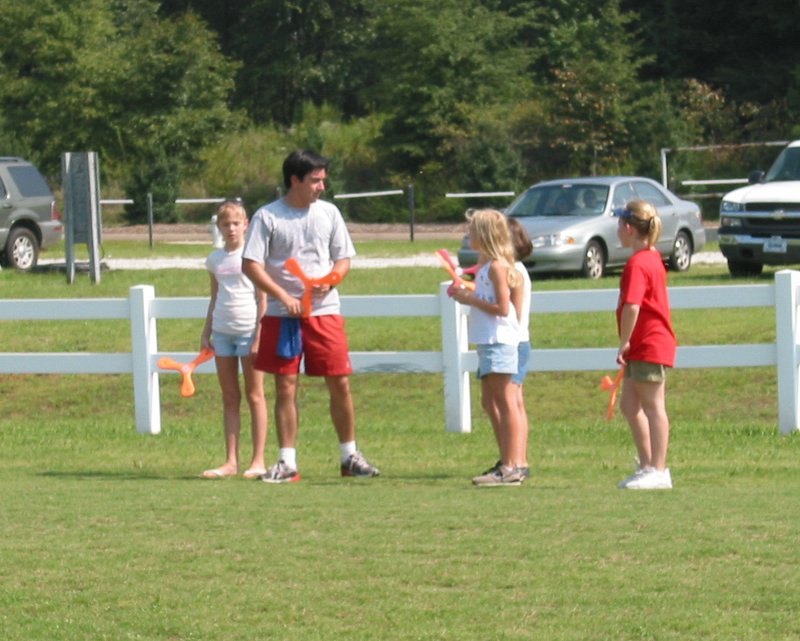 Ricardo teaching four young ladies to throw