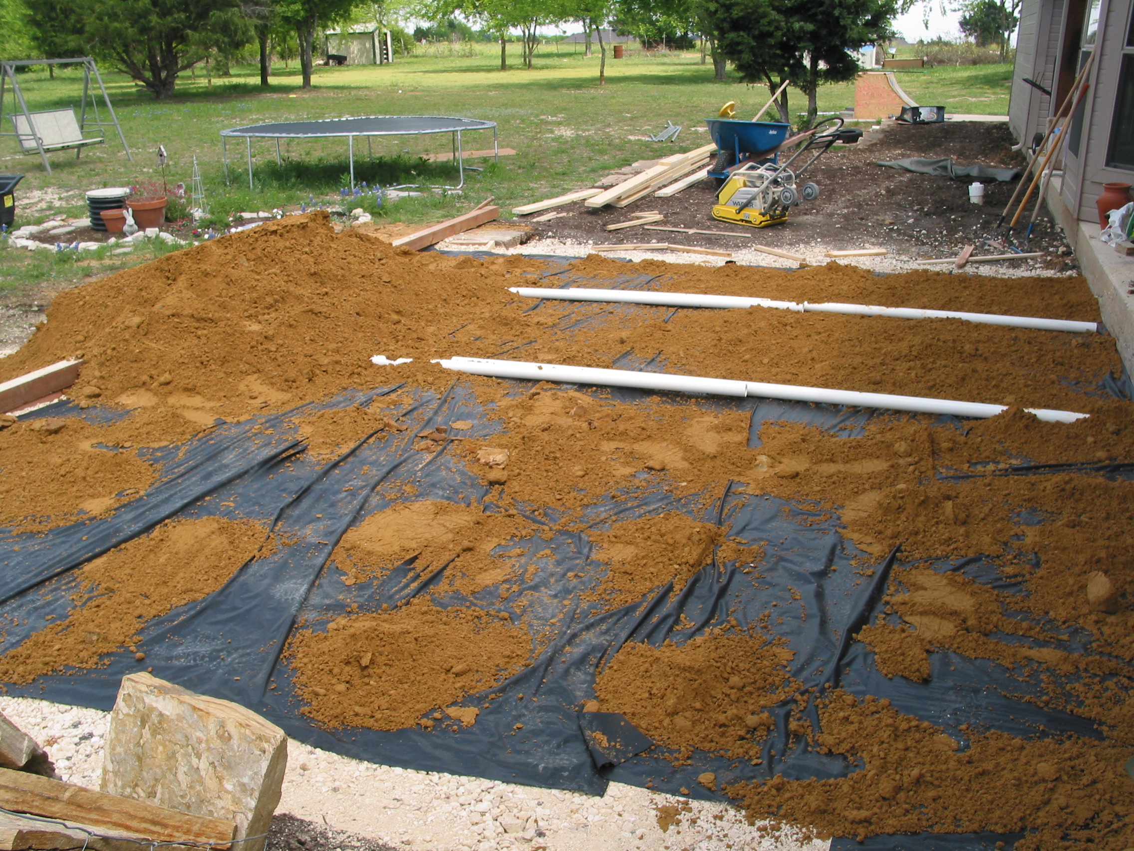 These pipes aren't for drainage. They are to help get the sand exactly 2 inches deep over the entire area.