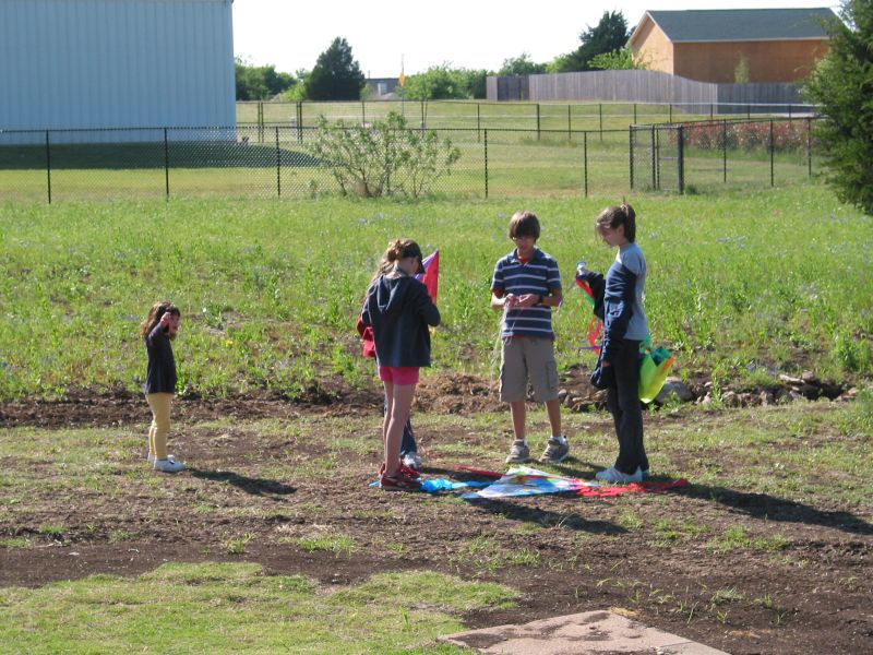 Ashley, Holly, Sarah, Andrew, and Jenny get ready to fly a kite.