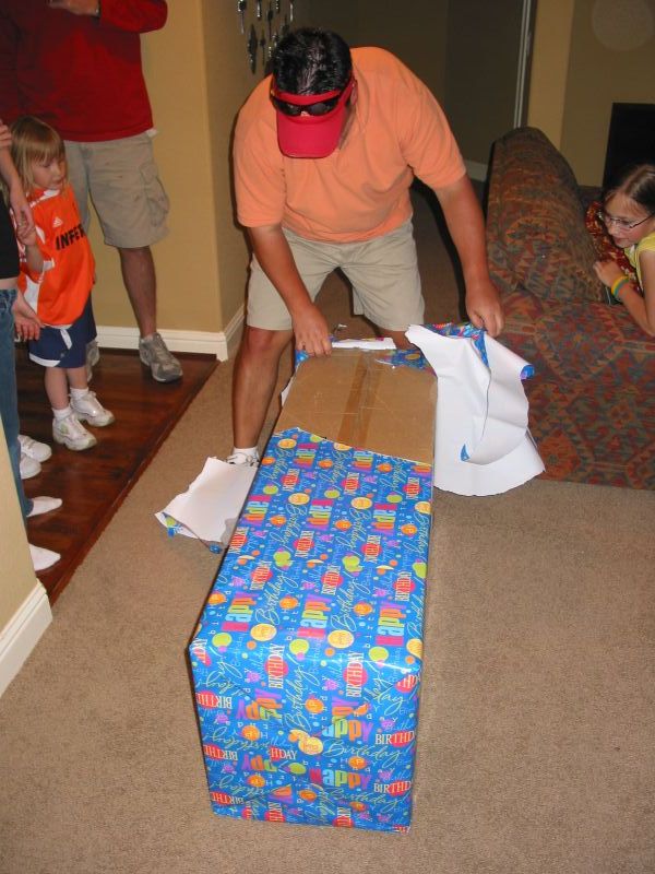 Bruce rips into the wrapping paper like a kid at Christmas.