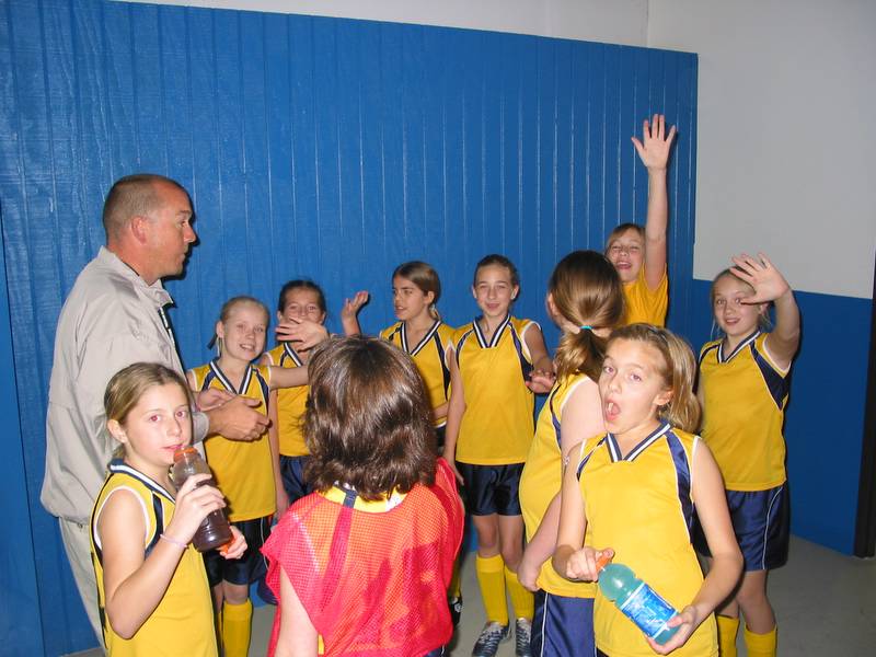 These girls should be listening to the coach, but instead they are looking at the camera
