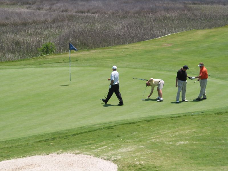 River's Edge - Rushing on the 18th Green